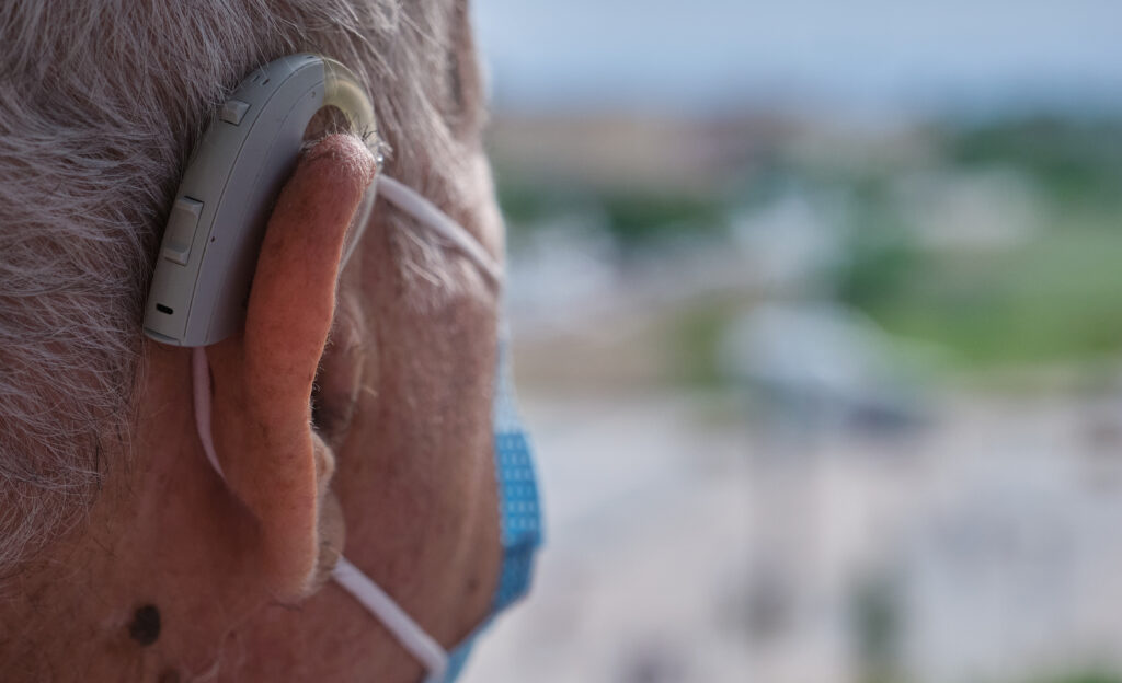 Elderly man with a hearing aid 