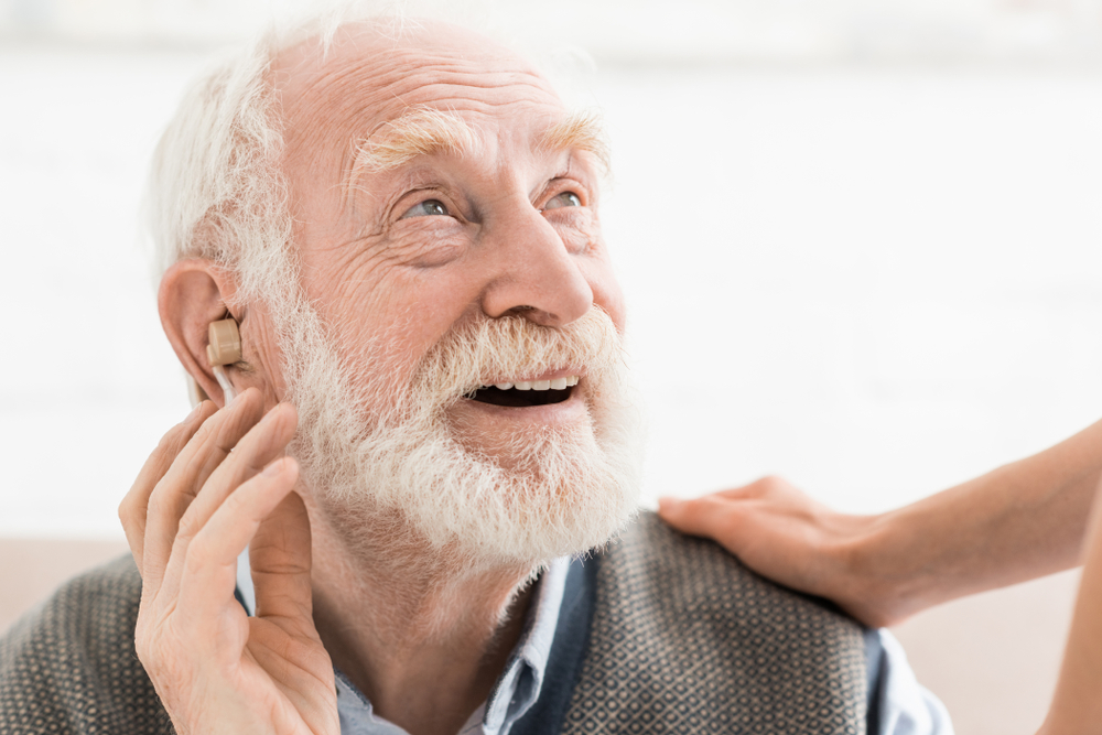 elder man with hearing aid