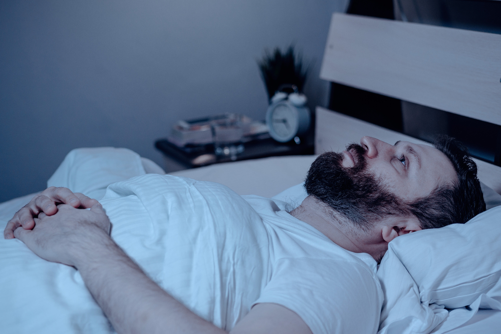 Man having sleep trouble due to Tinnitus